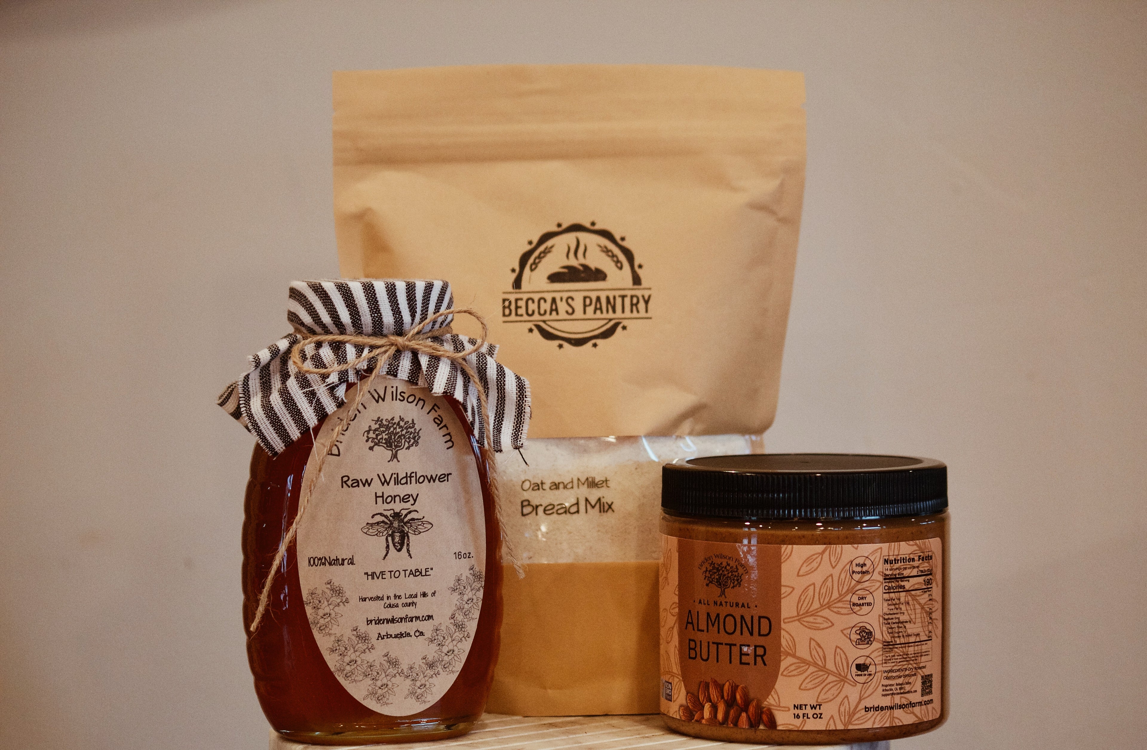 Jar of honey, bag of bread mix, and jar of almond butter from Becca&