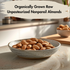 A bowl of organically grown raw unpasteurized nonpareil almonds on a kitchen counter.